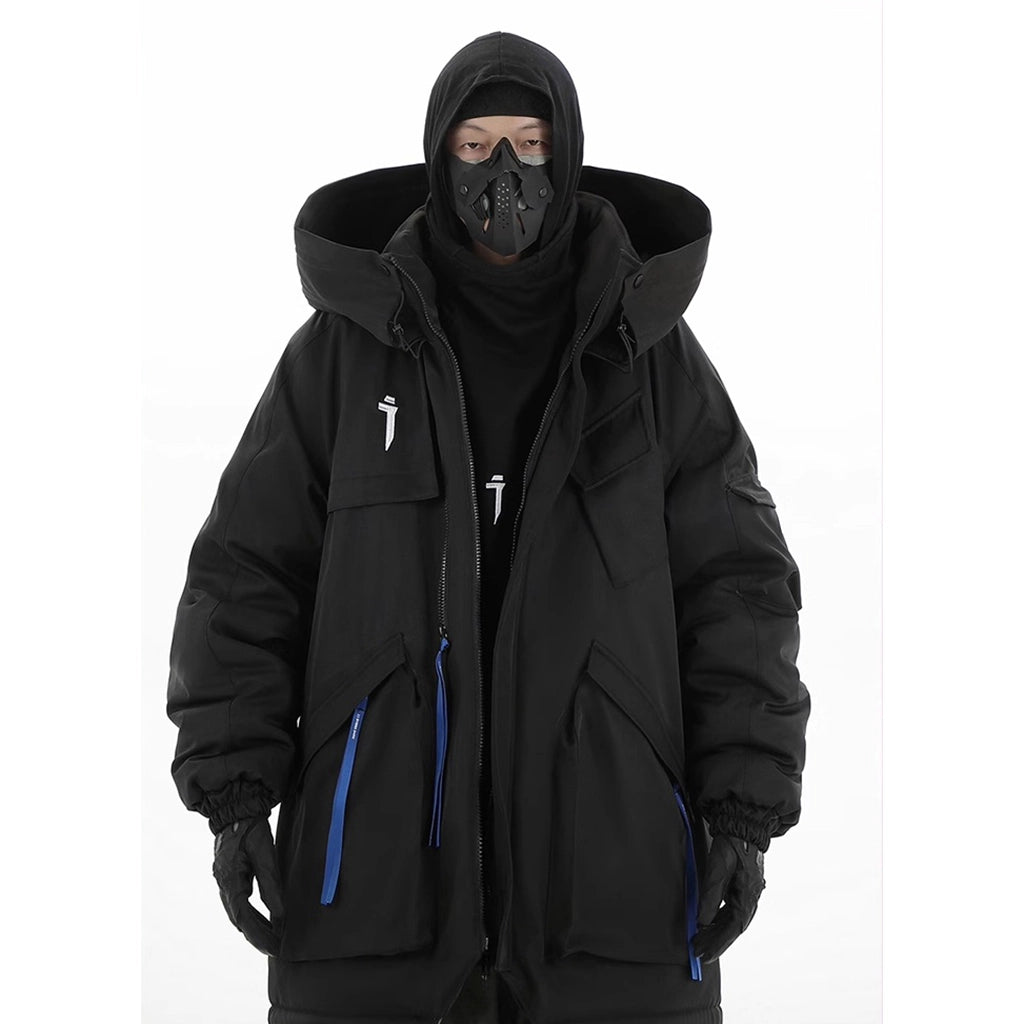 Model wearing an insulated black jacket with a high neck hood and mask, designed for winter survival and outdoor protection.